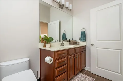 a bathroom with a sink vanity and toilet