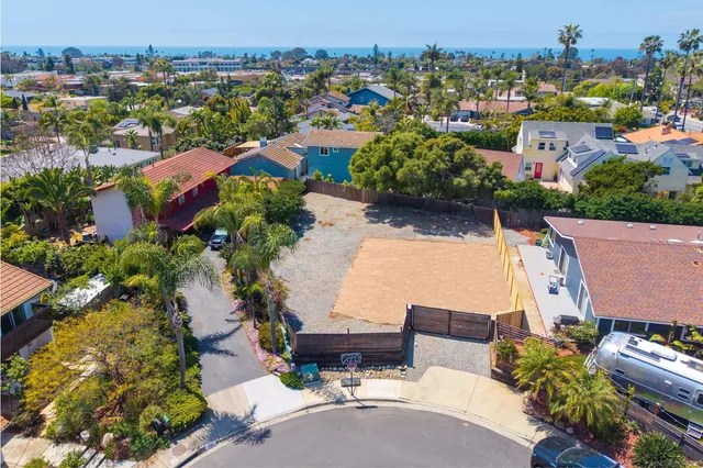 an aerial view of a house with a yard basket ball court and outdoor seating