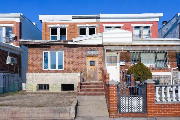 a front view of residential houses with cars parked