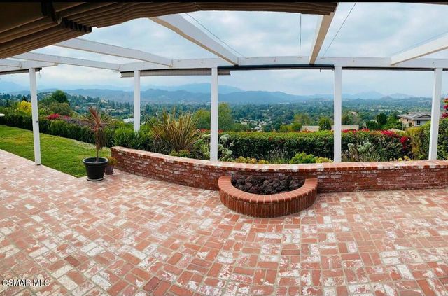 a view of a couches in patio with a yard