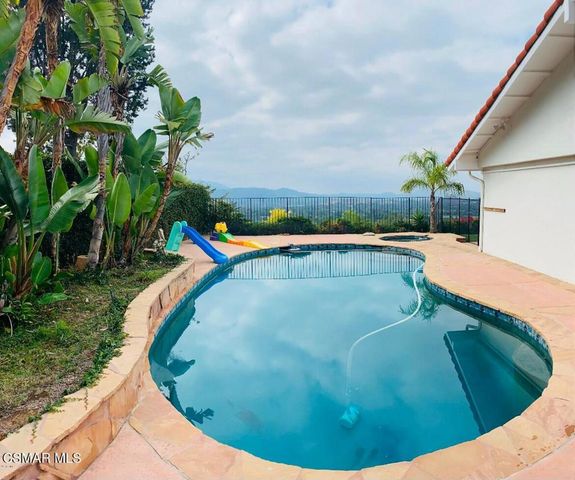 a view of a swimming pool with a yard