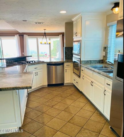 a kitchen with stainless steel appliances granite countertop a sink and cabinets