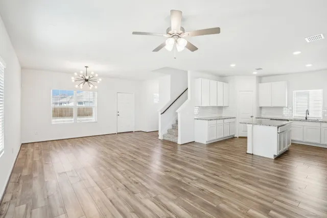 a view of a kitchen with wooden floor and a kitchen