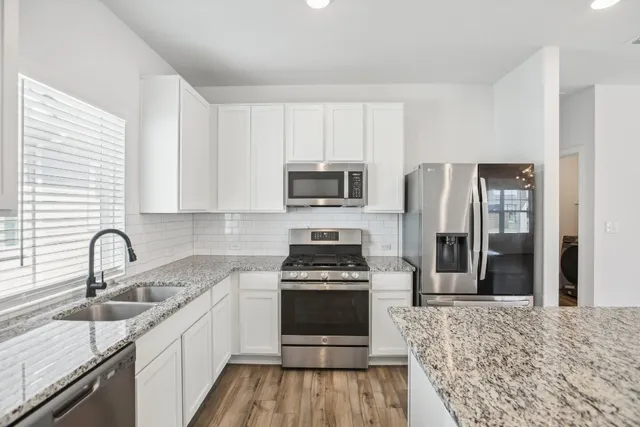 a kitchen with a sink stove and refrigerator