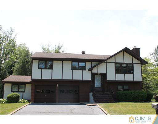 48 Smith Road Somerset, NJ 08873 - Photo 2 of 23 a front view of a house with a yard and garage