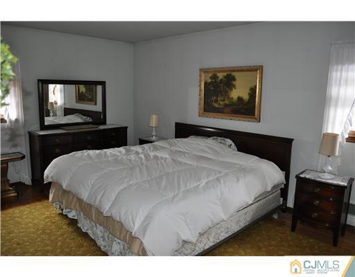 48 Smith Road Somerset, NJ 08873 - Photo 12 of 23 a bedroom with a bed and a painting on the wall