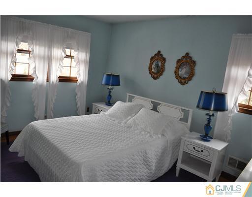 48 Smith Road Somerset, NJ 08873 - Photo 15 of 23 a bedroom with a bed and painting on the wall