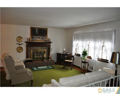 48 Smith Road Somerset, NJ 08873 - Photo 7 of 23 a living room with furniture and a fireplace