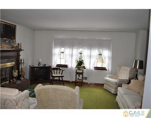 48 Smith Road Somerset, NJ 08873 - Photo 9 of 23 a living room with furniture a fireplace and a flat screen tv