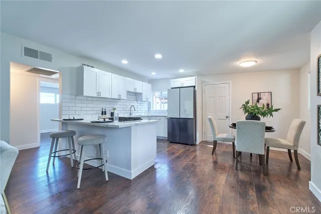 a kitchen with a table and chairs in it