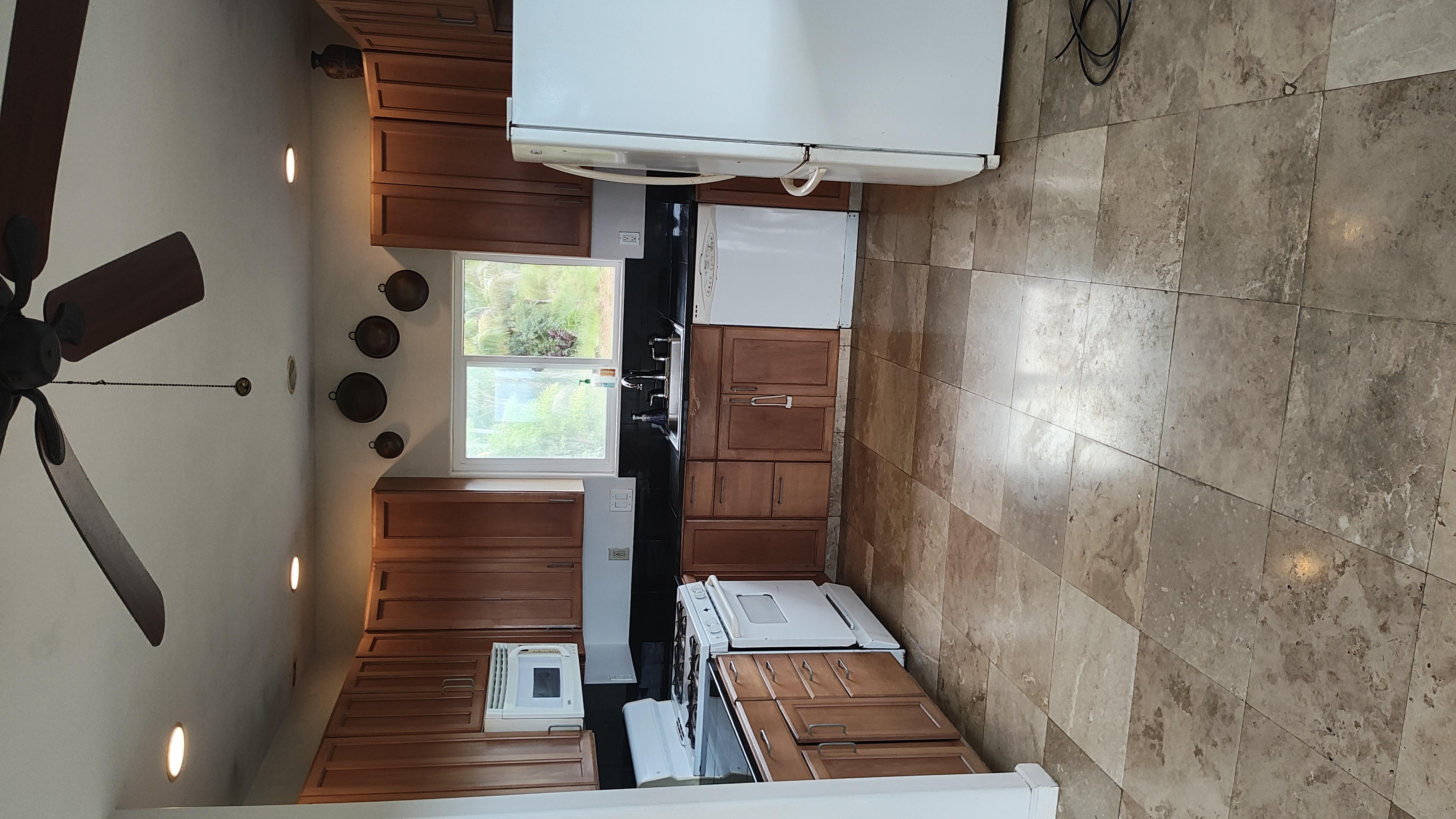 2525 Lot 62 Maikalani Street Hilo, HI 96720 - Photo 11 of 11 a large kitchen with stainless steel appliances granite countertop a stove a sink a refrigerator and a cabinets