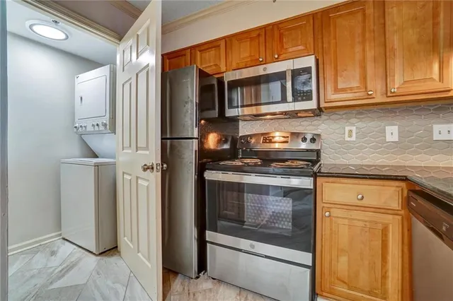an empty room with wooden floor chandelier fan and windows