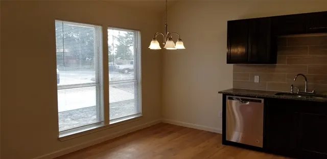 a view of a sink storage and utility room with wooden floor