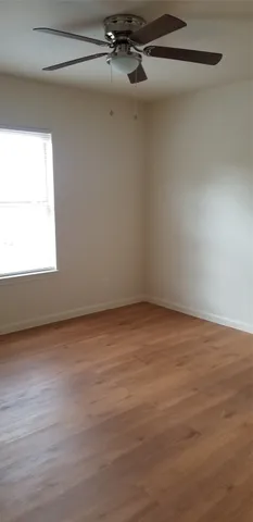a view of a room with wooden floor