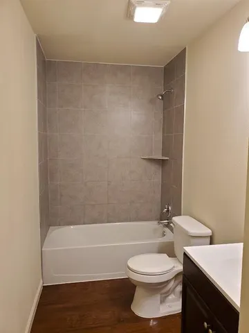 a bathroom with a toilet a sink and bathtub