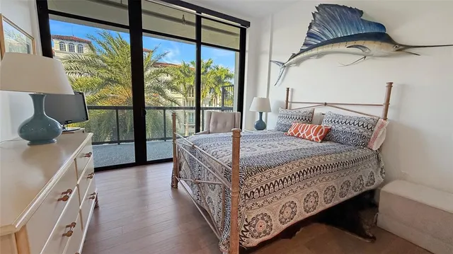 a bedroom with a bed a lamp and a large window