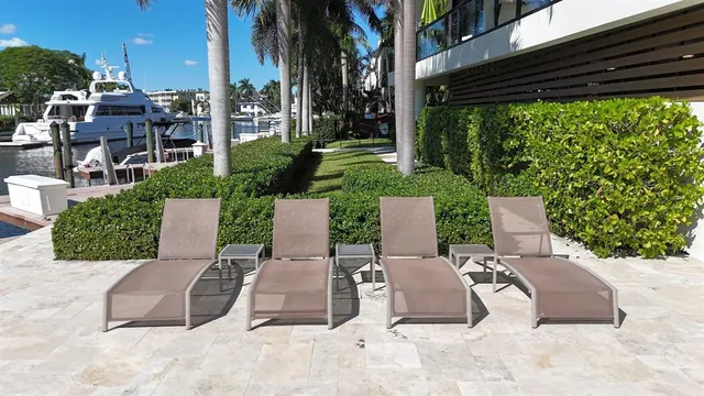 a view of a patio with a table and chairs and potted plants