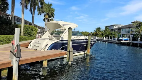 a view of a patio with table and chairs with wooden floor and fence