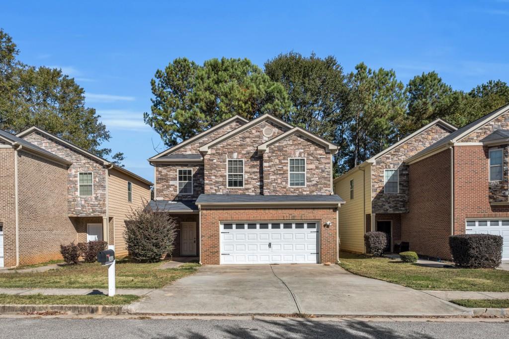 1482 Persimmon Trace Morrow, GA 30260 - Photo 1 of 1 a front view of a house with a garage