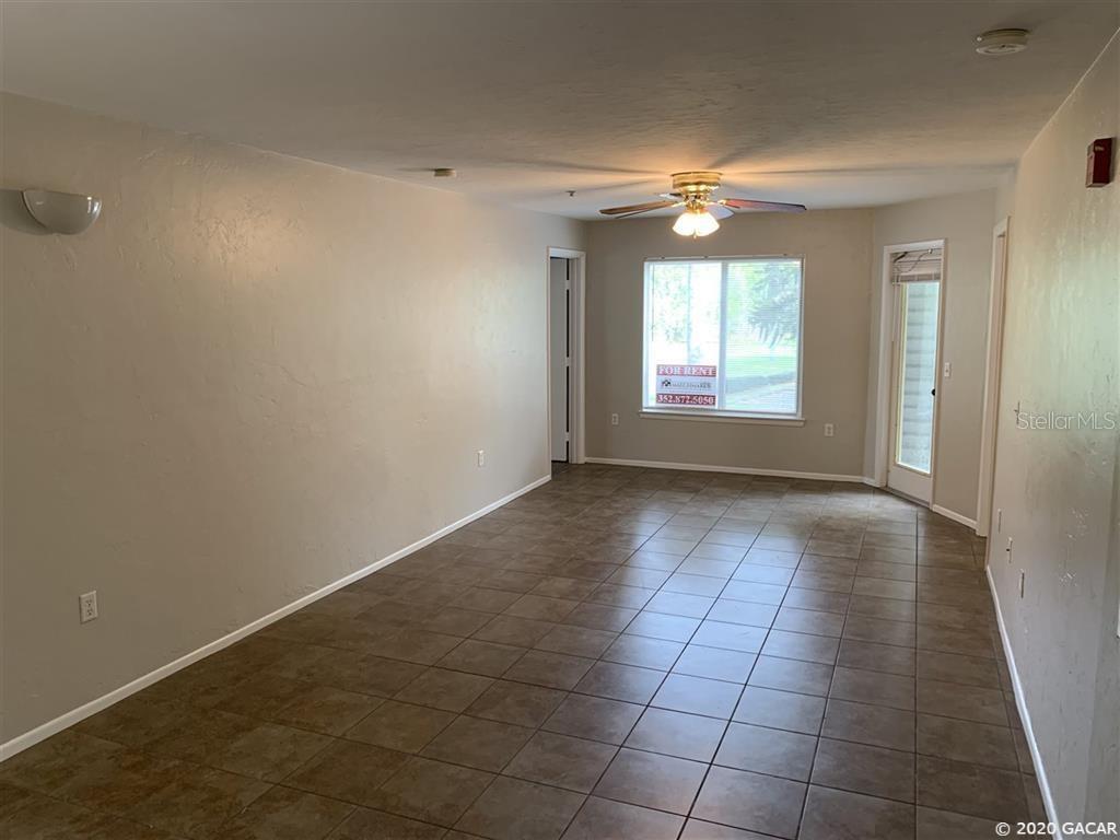 4000 Southwest 23rd Street, Unit 3203 Gainesville, FL 32608 - Photo 1 of 1 en empty room with windows and chandelier fan