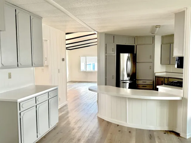 a view of a kitchen counter space with wooden floor