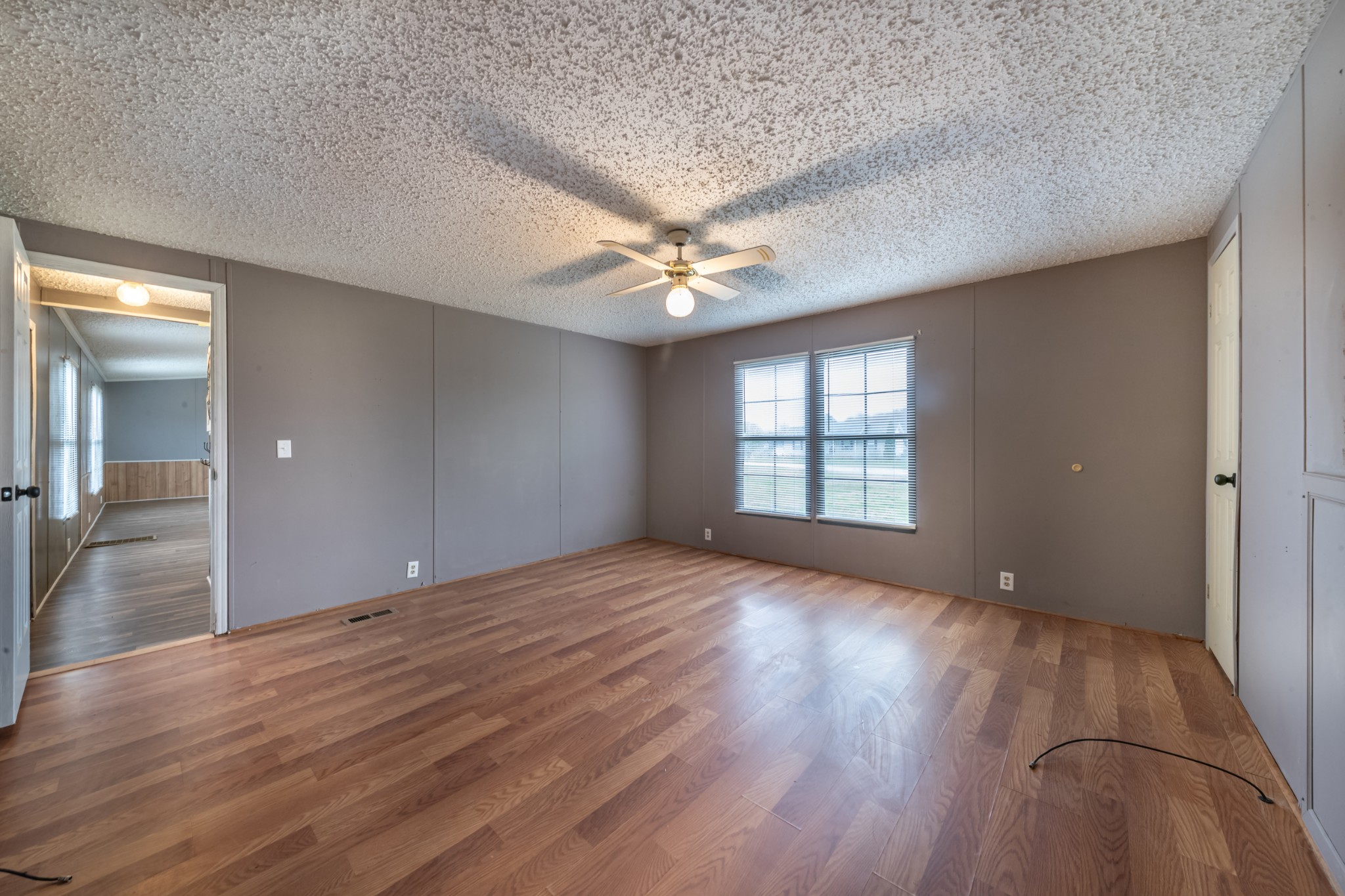234 Dunn Fall River Road Lawrenceburg, TN 38464 - Photo 5 of 12 a view of an empty room with a window and wooden floor