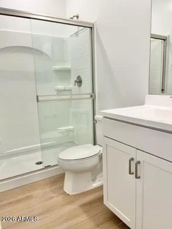 a bathroom with a toilet and a shower