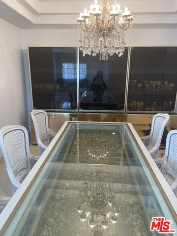 a view of a swimming pool with a couches and dining table