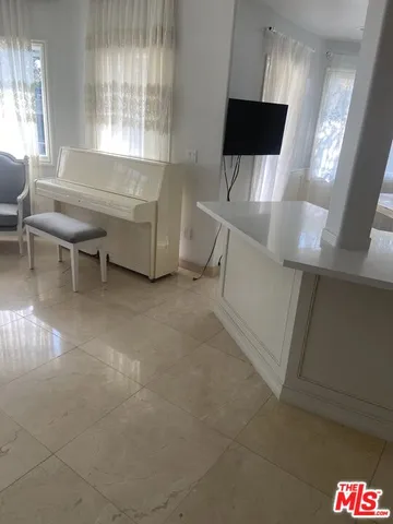 a view of kitchen with refrigerator and window