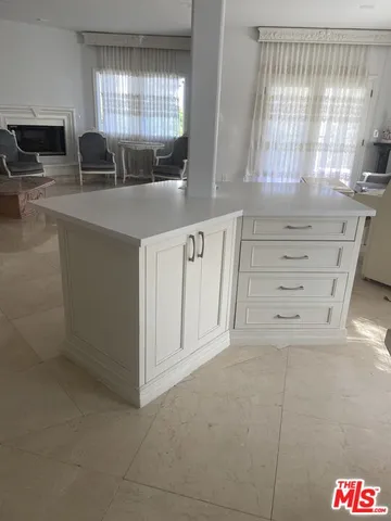a bathroom with a granite countertop sink and a bathtub