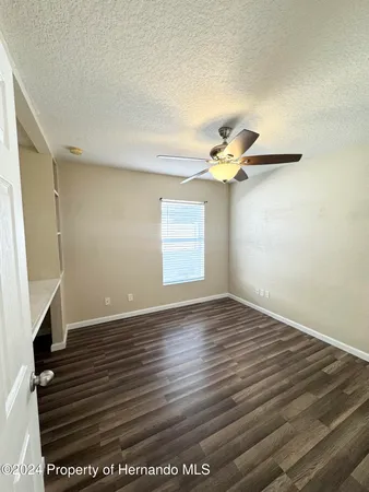 a view of livingroom with hardwood floor and a ceiling fan