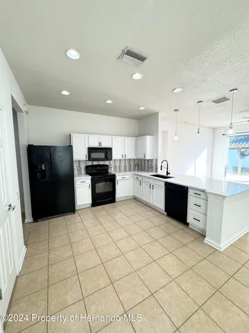 a large kitchen with stainless steel appliances lots of counter space and cabinets