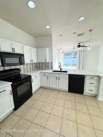 a kitchen with a cabinets and appliances