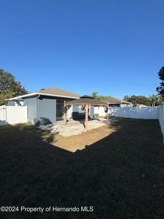 a view of house with yard and seating area