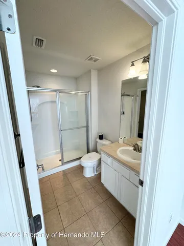 a bathroom with a double vanity sink toilet and shower