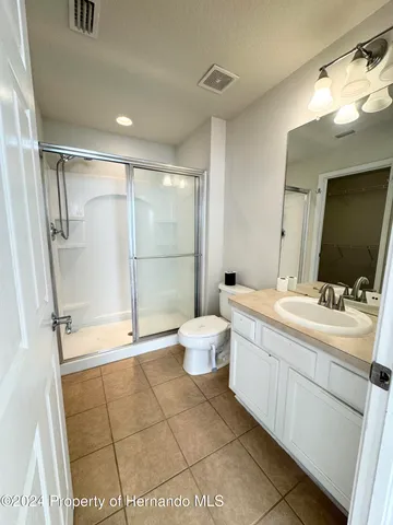 a bathroom with a double vanity sink mirror and toilet