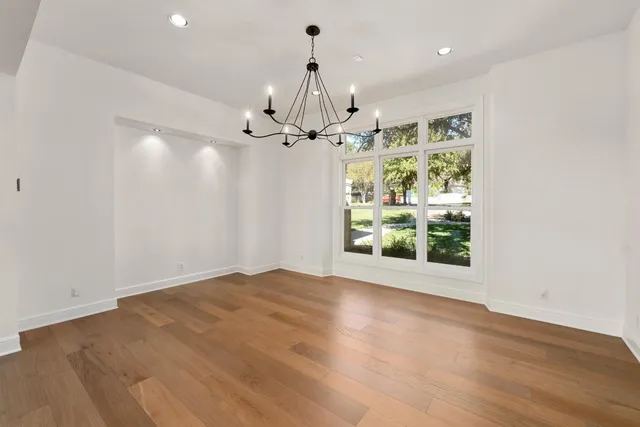 a large kitchen with stainless steel appliances a stove and a sink