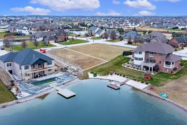 an aerial view of residential houses with outdoor space and parking