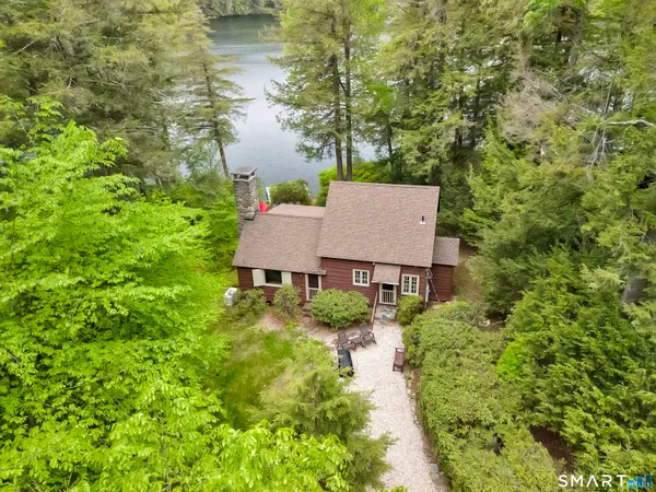 a aerial view of a house with yard and lake view