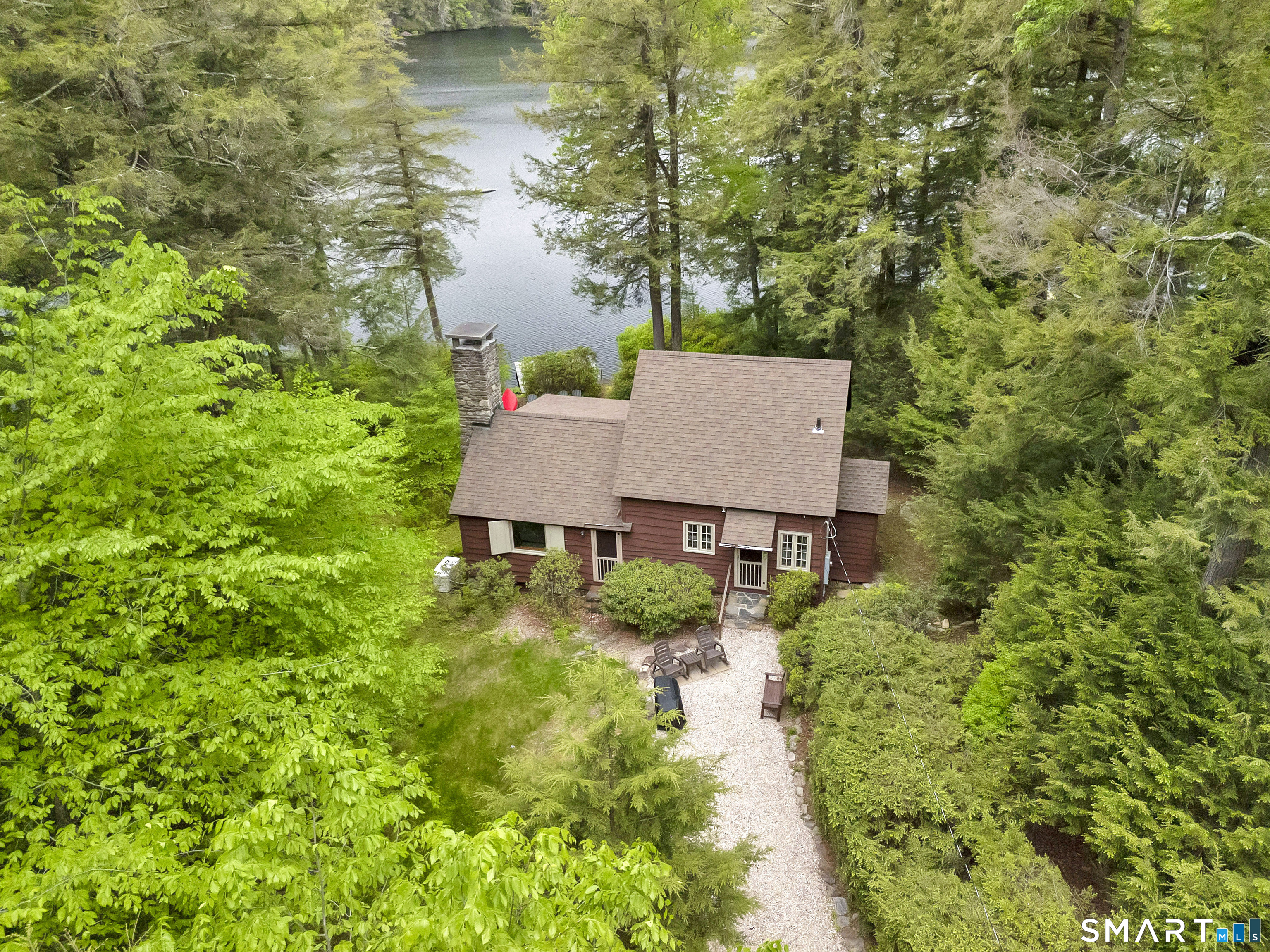 a aerial view of a house with yard and lake view
