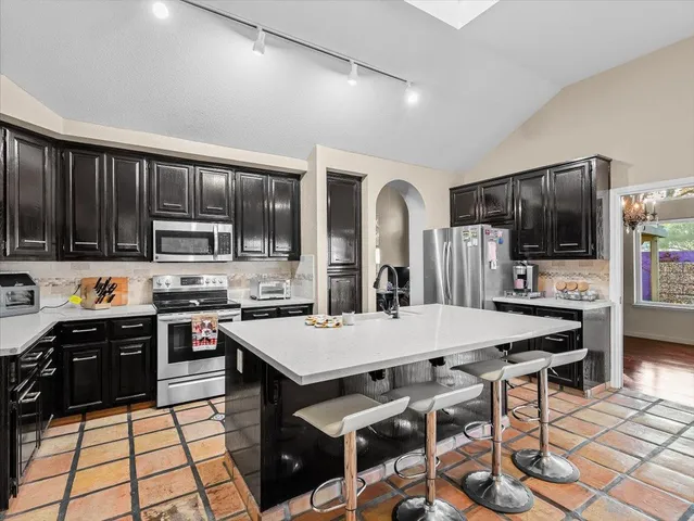 a bathroom with a granite countertop sink a toilet and a mirror