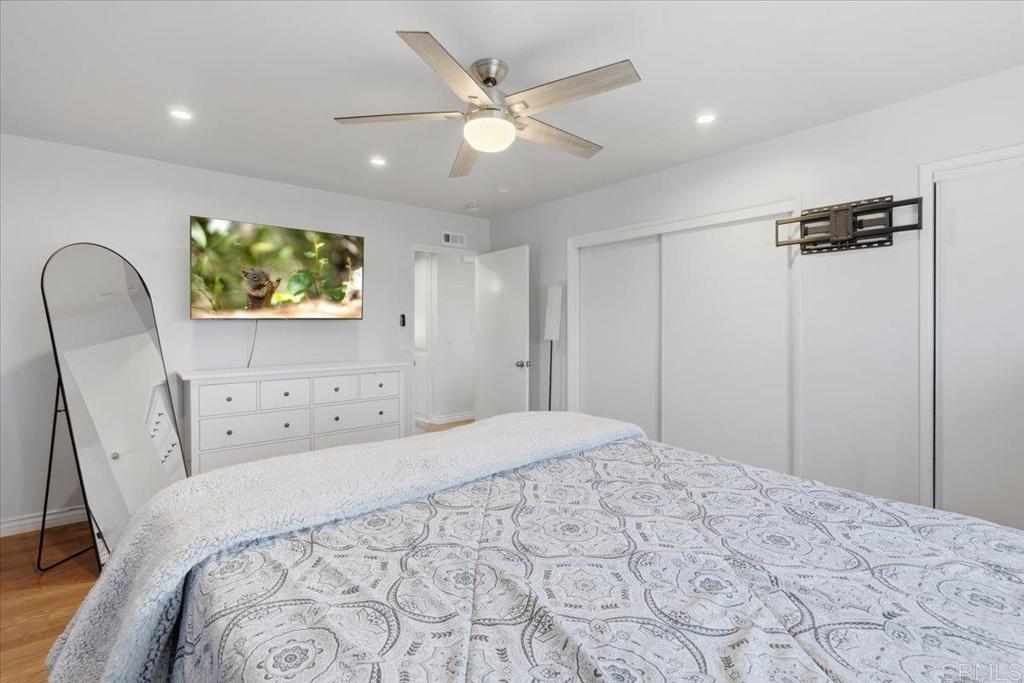 1915 Edith Drive Escondido, CA 92026 - Photo 11 of 41 a bedroom with a large bed and a chandelier