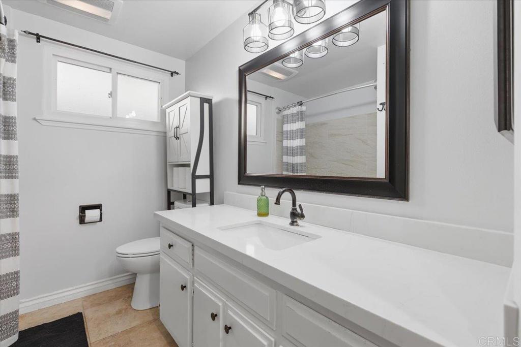 1915 Edith Drive Escondido, CA 92026 - Photo 12 of 41 a bathroom with a sink a toilet and a mirror