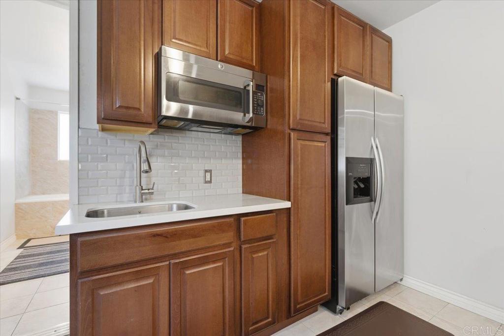 1915 Edith Drive Escondido, CA 92026 - Photo 17 of 41 a kitchen with stainless steel appliances a refrigerator and cabinets