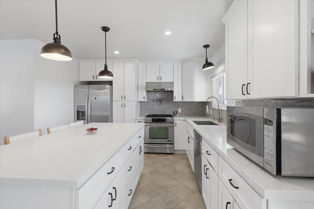 1915 Edith Drive Escondido, CA 92026 - Photo 4 of 41 a kitchen with a stove a sink and a refrigerator