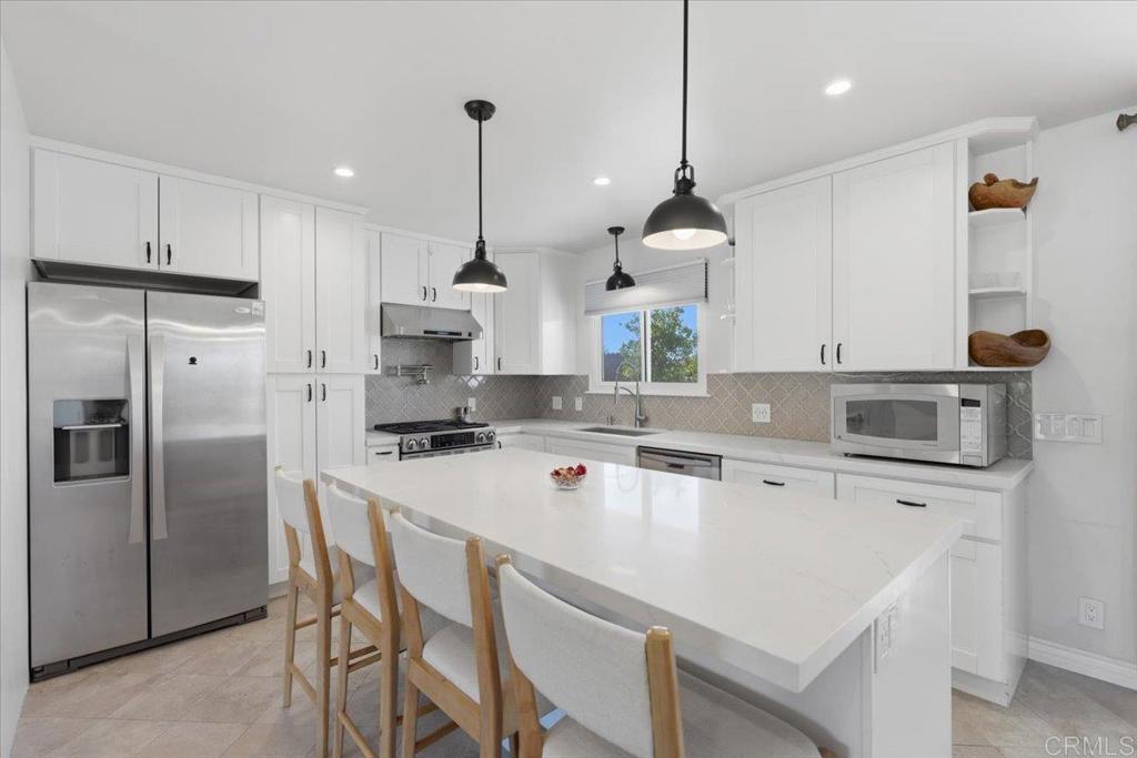 1915 Edith Drive Escondido, CA 92026 - Photo 5 of 41 a kitchen with a sink a center island stainless steel appliances and cabinets