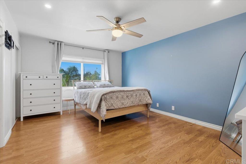 1915 Edith Drive Escondido, CA 92026 - Photo 10 of 41 a bedroom with a large bed and a ceiling fan