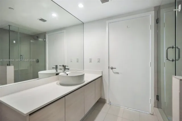 a bathroom with a sink and mirror