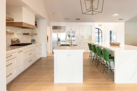 a kitchen with stainless steel appliances granite countertop a sink stove and cabinets