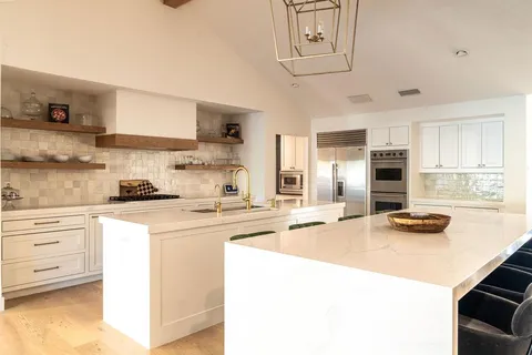 a kitchen with cabinets a sink and appliances